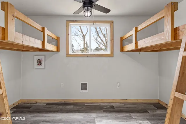 a view of a closet area with wooden floor