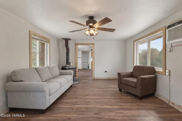 a living room with furniture and a chandelier