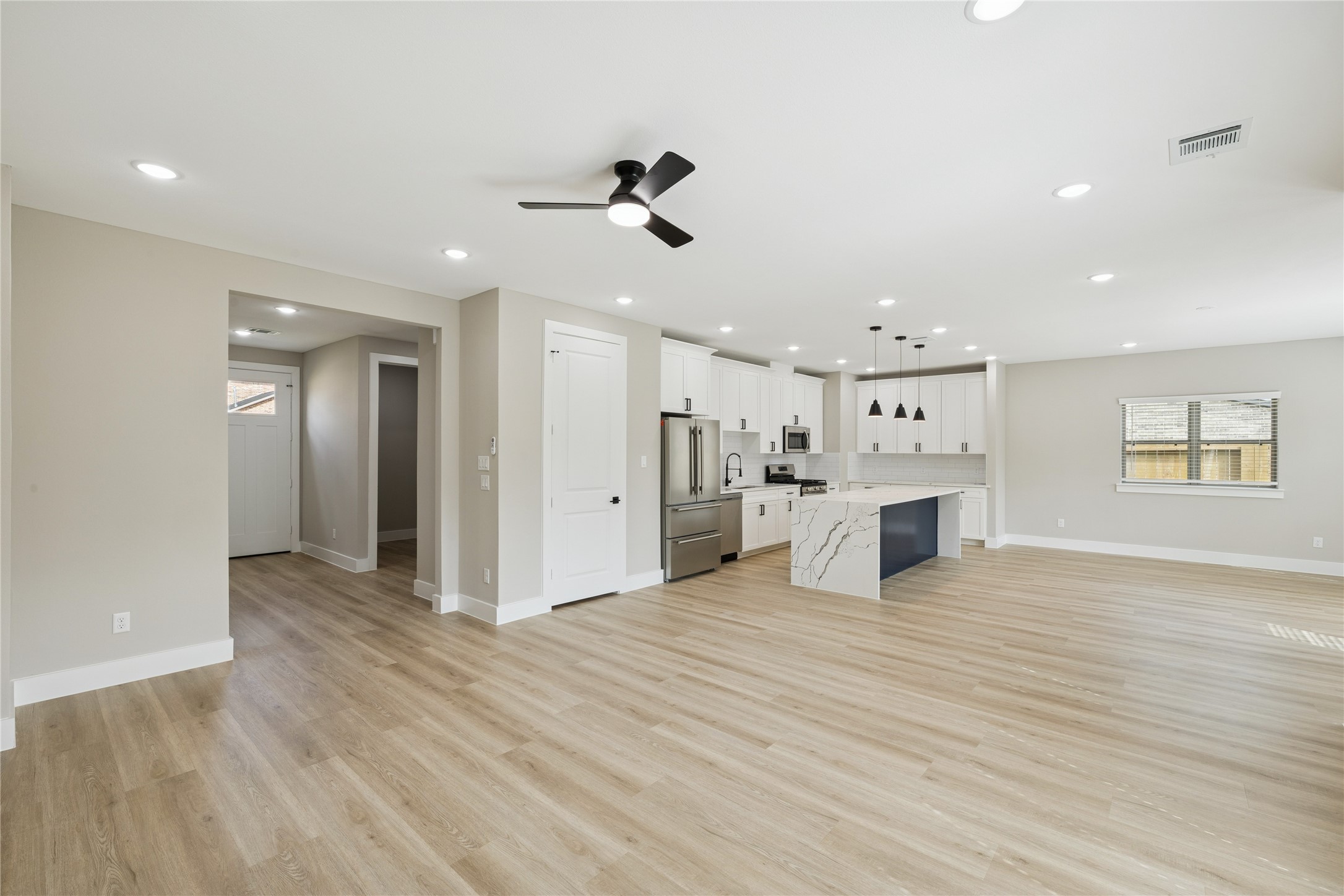 2602 Martinas Ct Spring Spring, TX 77388 - Photo 7 of 24 a view of a kitchen with kitchen island stainless steel appliances refrigerator stove and wooden floor
