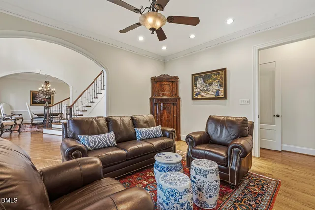 a living room with furniture a large window and a fireplace