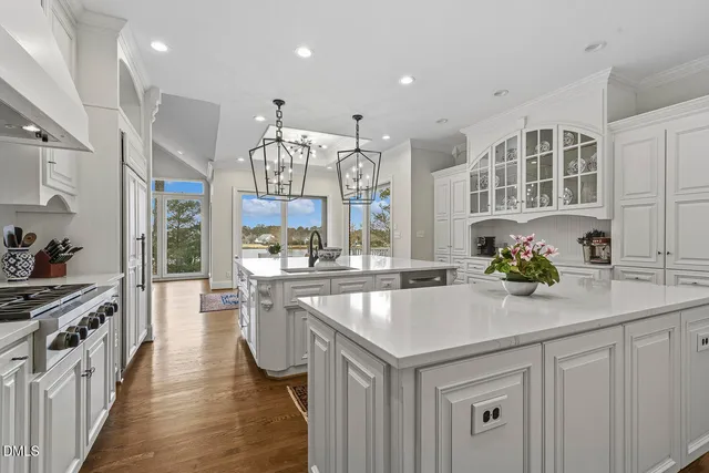 a spacious bathroom with a double vanity sink a large mirror and a bathtub