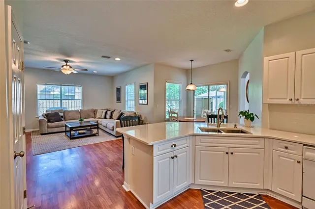 a kitchen with a sink appliances and cabinets