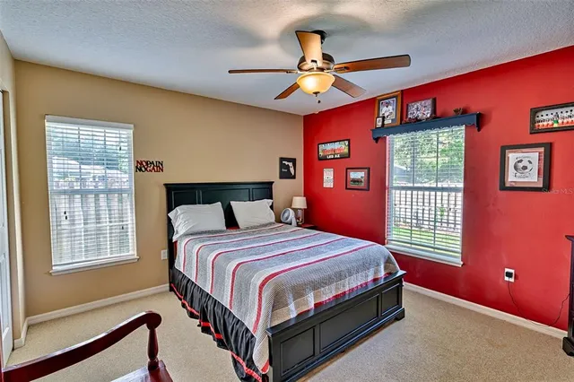 a bedroom with a bed dresser and a window