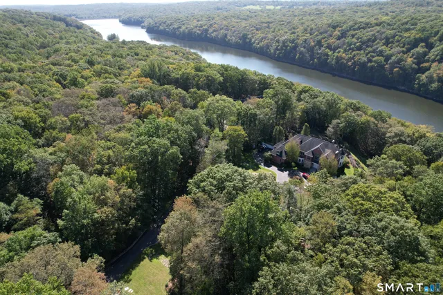 an aerial view of a house with a yard