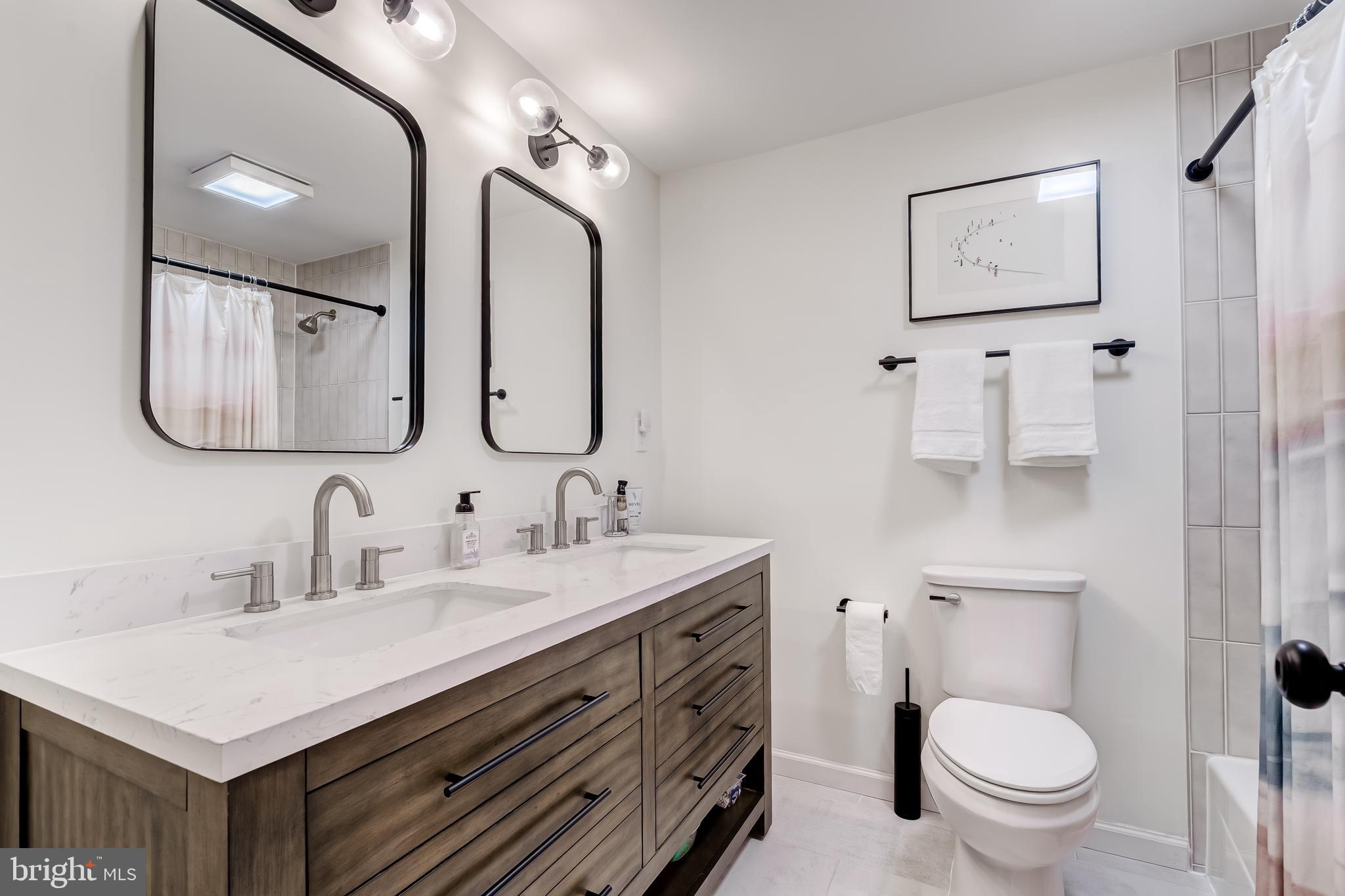 11926 Appling Valley Road Fairfax, VA 22030 - Photo 14 of 60 a bathroom with a toilet a sink a mirror and vanity