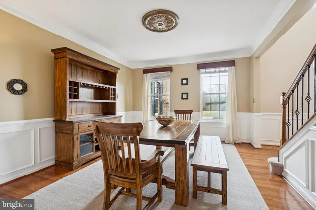 a kitchen with stainless steel appliances a sink stove and wooden floor