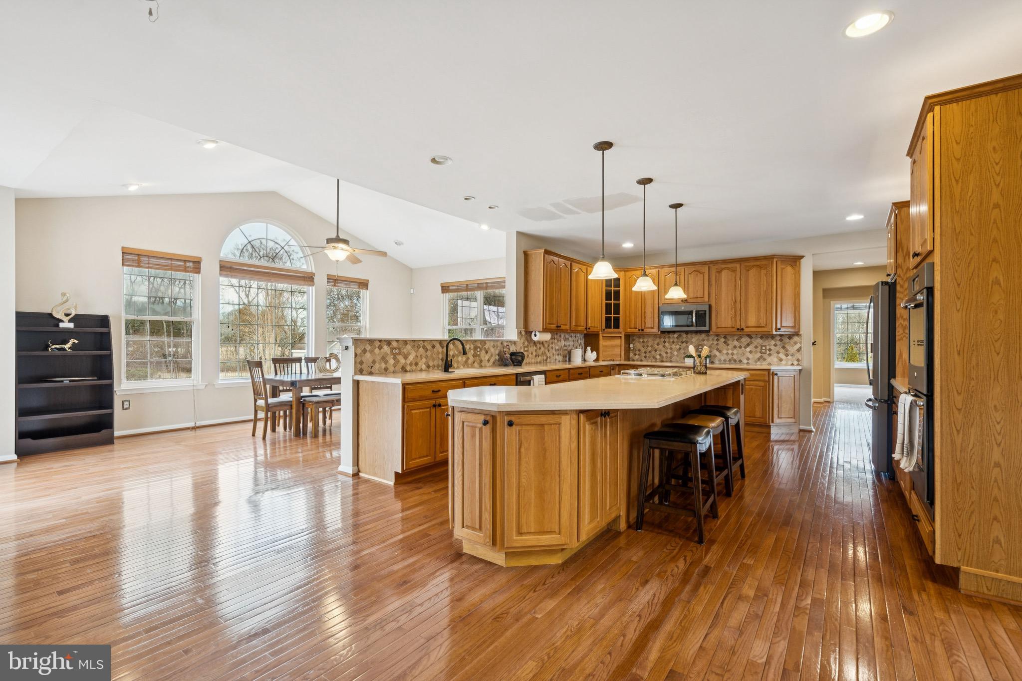 253 Jennings Way Mickleton, NJ 08056 - Photo 9 of 62 an open kitchen with wooden floor and stainless steel appliances