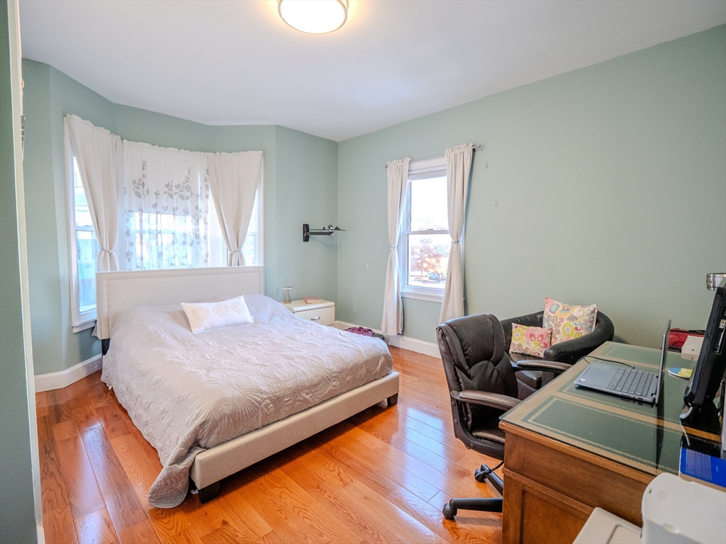 2 Hillside Avenue Somerville, MA 02145 - Photo 13 of 40 a bedroom with a bed and a window