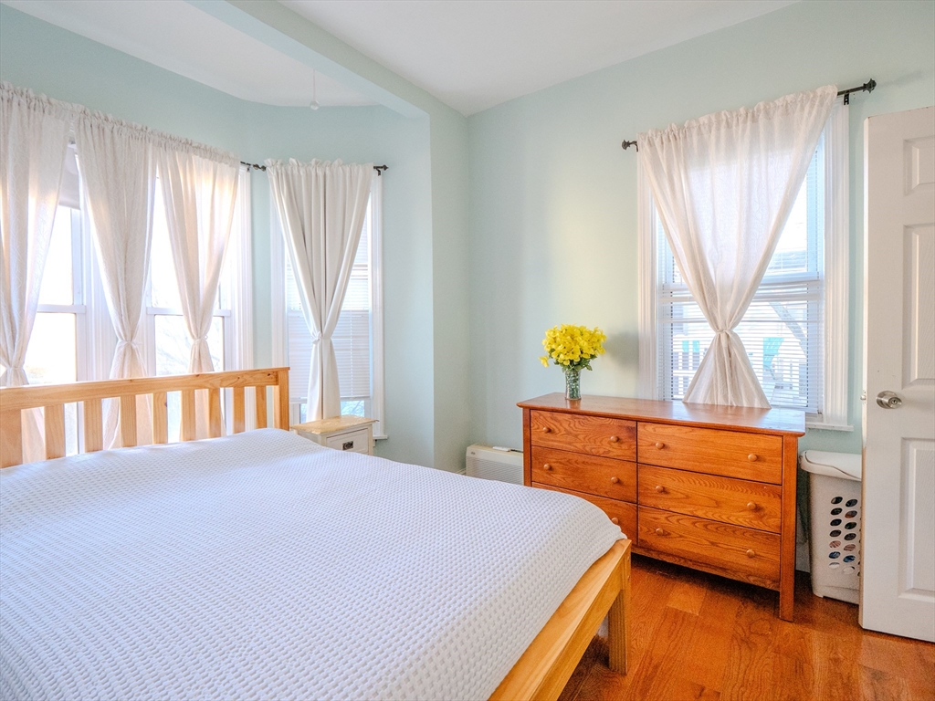 2 Hillside Avenue Somerville, MA 02145 - Photo 16 of 40 a bedroom with a bed and wooden floor