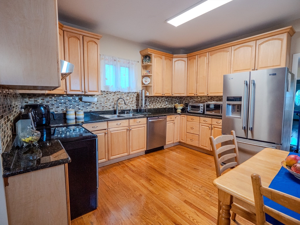 2 Hillside Avenue Somerville, MA 02145 - Photo 17 of 40 a kitchen with stainless steel appliances granite countertop a sink stove and refrigerator