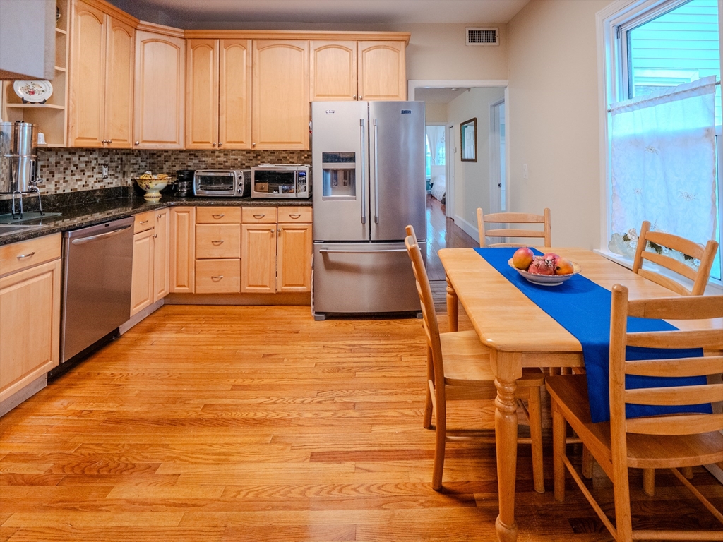 2 Hillside Avenue Somerville, MA 02145 - Photo 18 of 40 a kitchen with stainless steel appliances granite countertop a stove and a refrigerator