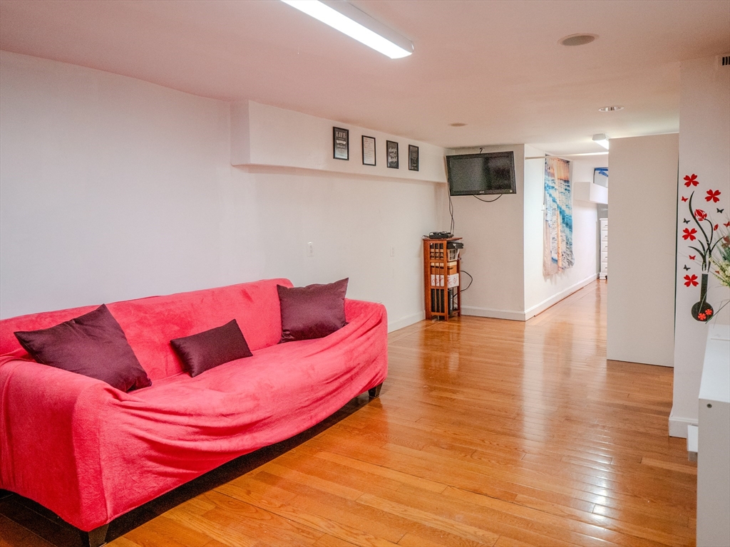 2 Hillside Avenue Somerville, MA 02145 - Photo 21 of 40 a living room with furniture and a wooden floor
