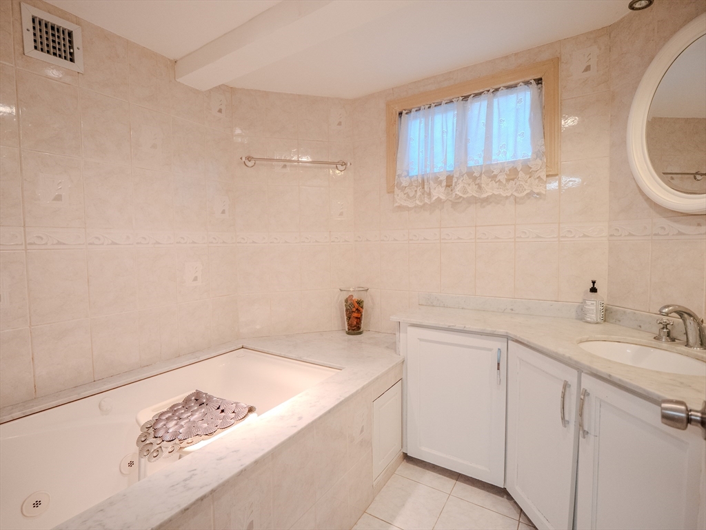2 Hillside Avenue Somerville, MA 02145 - Photo 25 of 40 a bathroom with a sink and a mirror