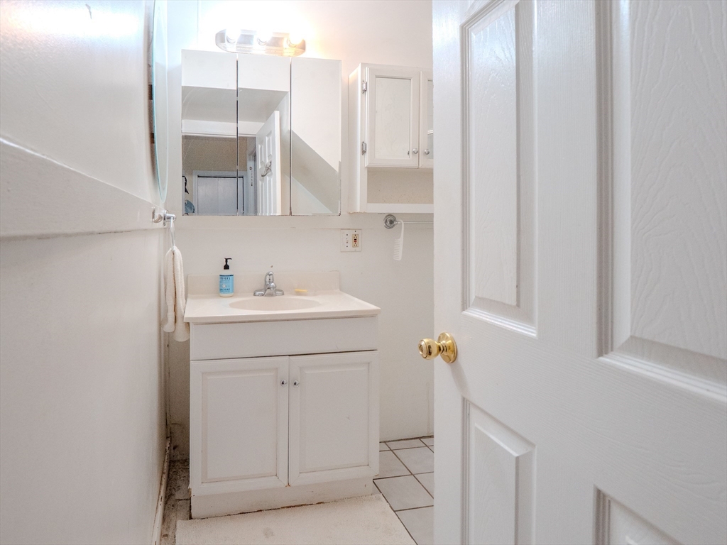 2 Hillside Avenue Somerville, MA 02145 - Photo 28 of 40 a bathroom with a sink and a mirror