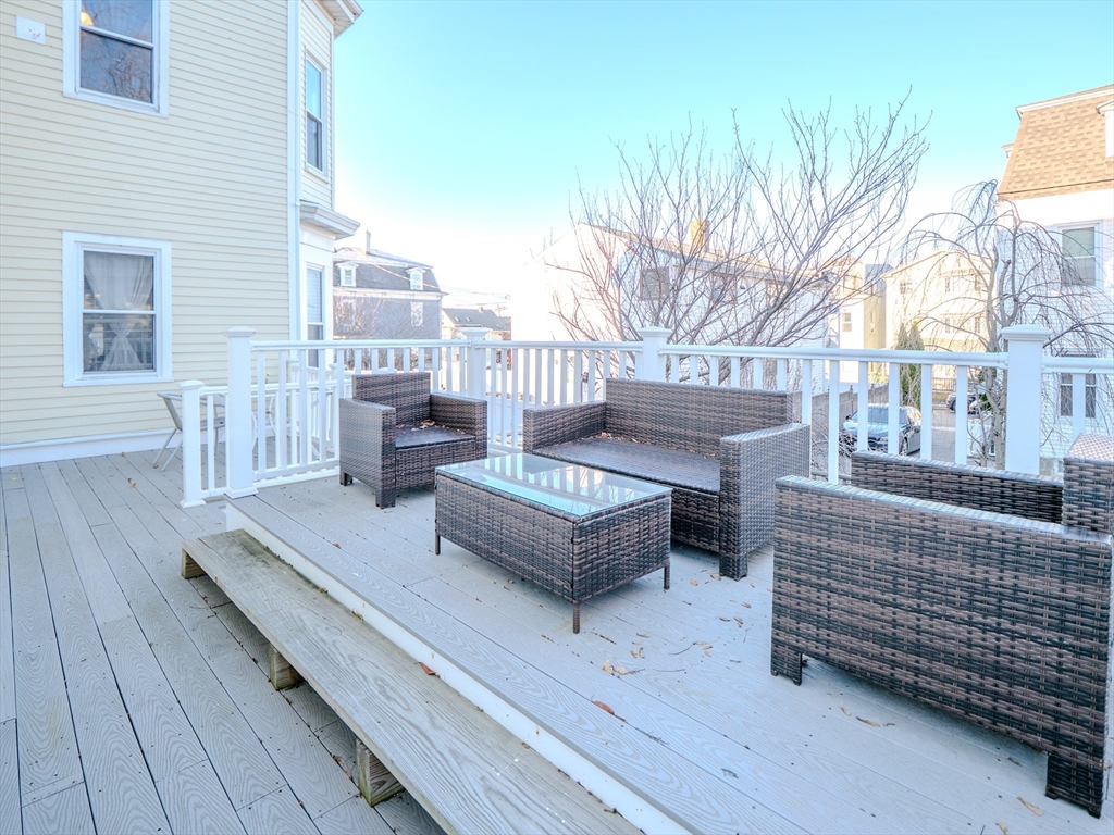 2 Hillside Avenue Somerville, MA 02145 - Photo 7 of 40 a view of a roof deck with couches and wooden floor