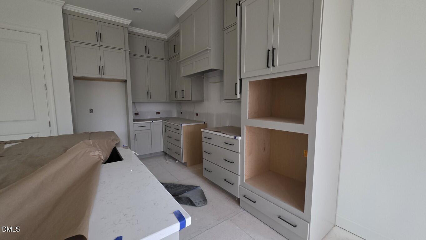 824 Willow Tower Court Rolesville, NC 27571 - Photo 11 of 30 a kitchen with white cabinets and white appliances