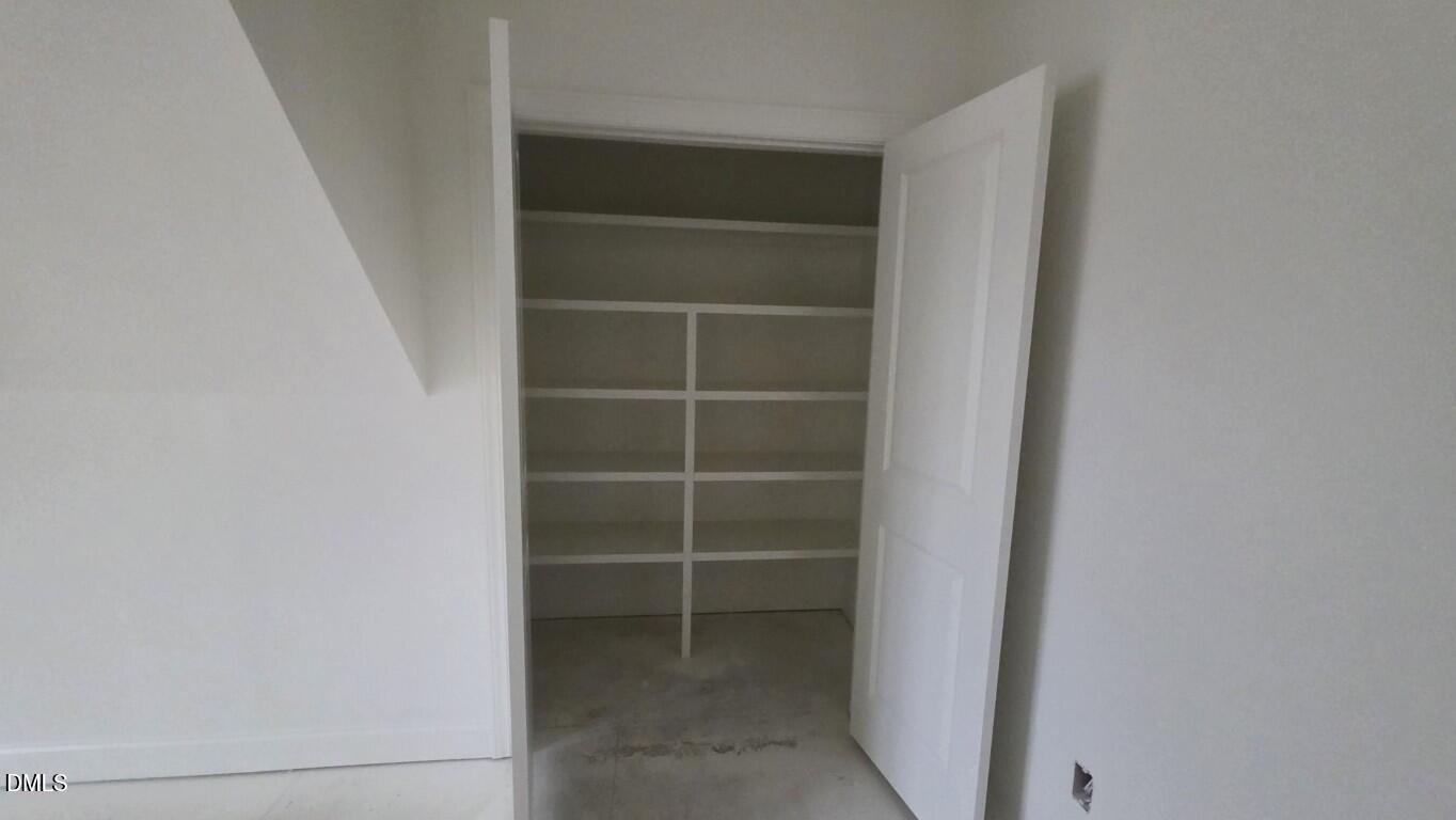 824 Willow Tower Court Rolesville, NC 27571 - Photo 25 of 30 a view of walk in closet with empty racks