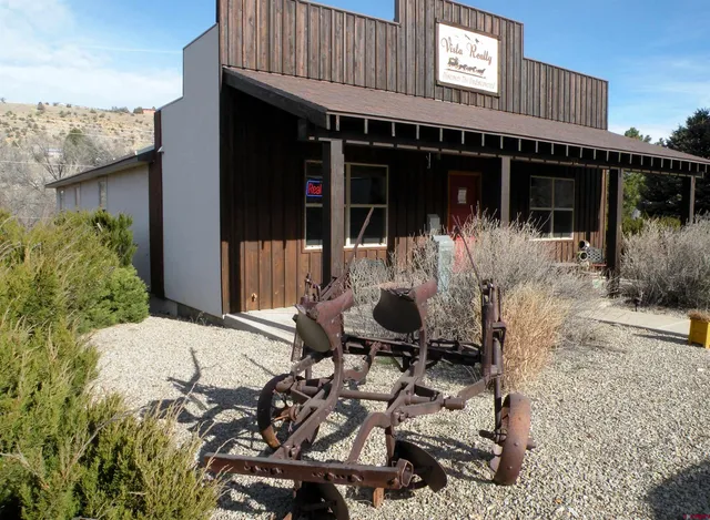 a front view of a house with sitting area