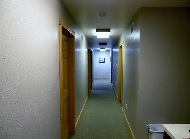a view of hallway with a bathroom