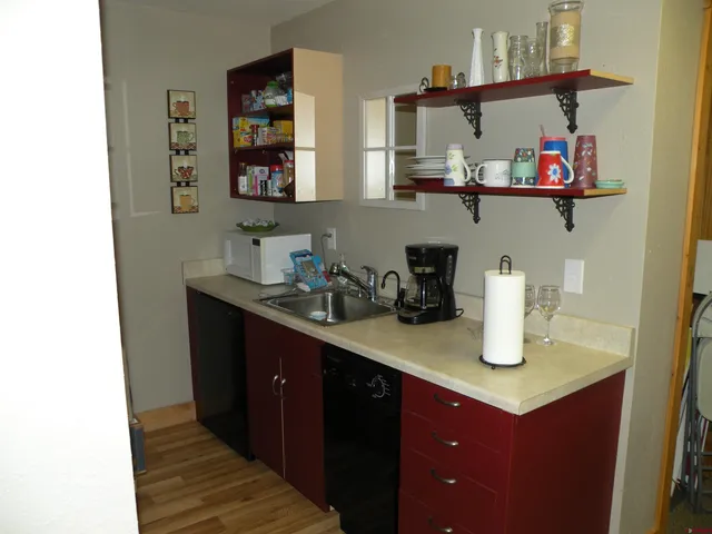 a kitchen with a sink dishwasher and cabinets