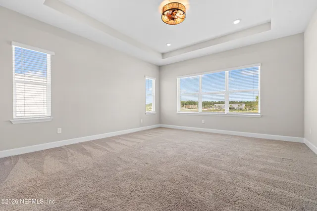a view of a room with gym equipment and a large window