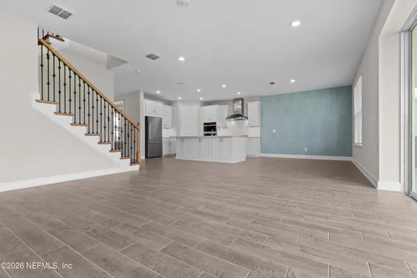 a kitchen with stainless steel appliances granite countertop a refrigerator and a stove