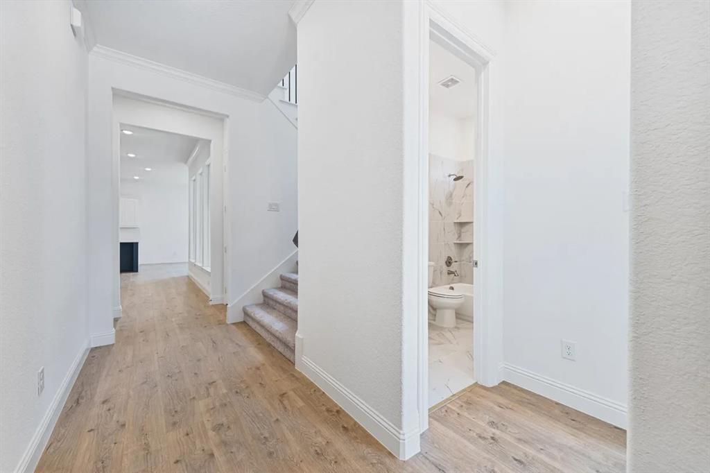 9337 Loggerhead Way Fort Worth, TX 76118 - Photo 8 of 40 a view of hallway with wooden floor