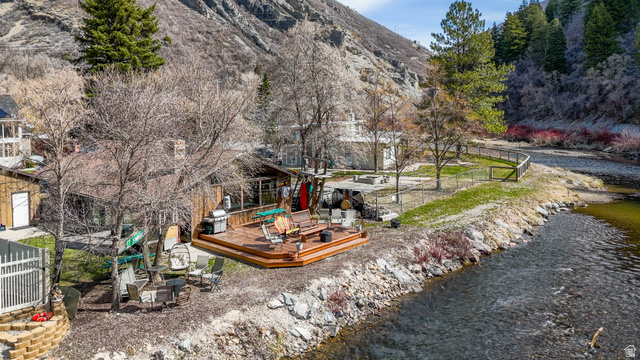 3711 North Canyon Road Provo, UT 84604 - Photo 36 of 42 View of home's community featuring a deck with water view, a patio area, and an outdoor fire pit