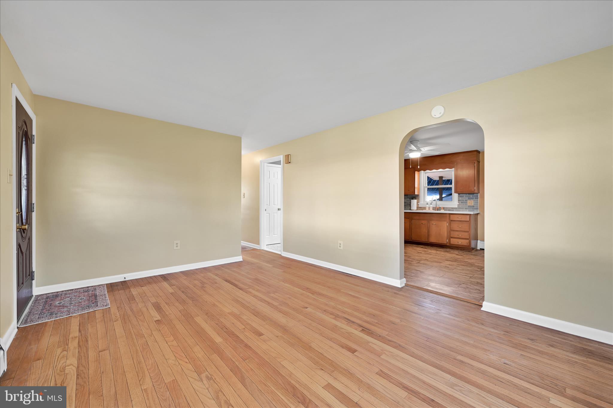 986 Fritztown Road Reading, PA 19608 - Photo 11 of 45 an empty room with wooden floor and a window