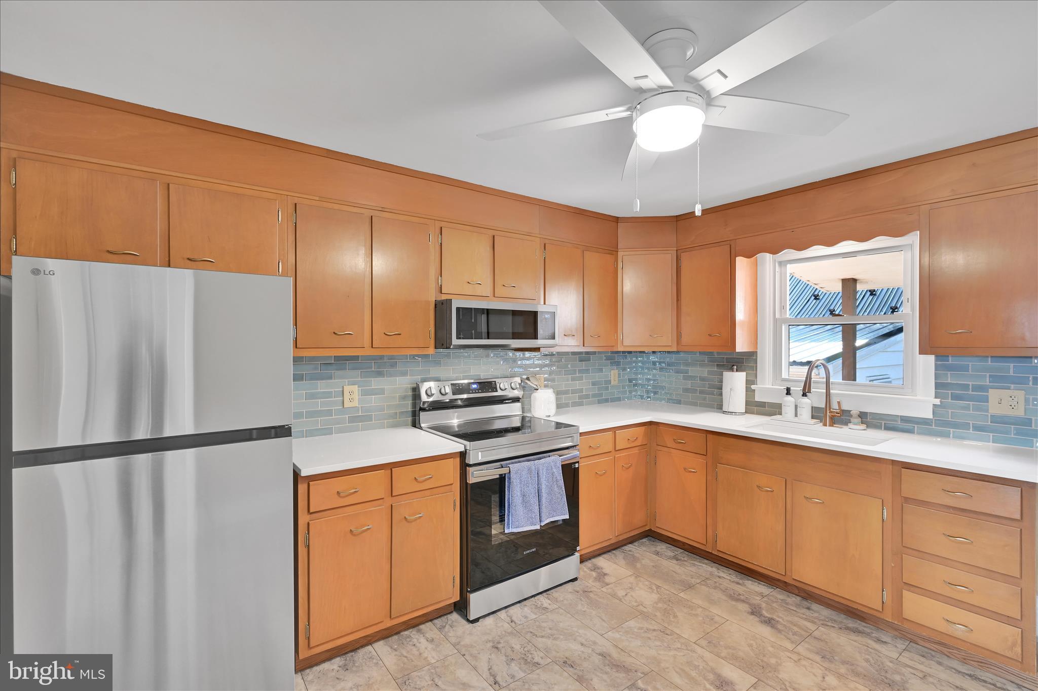 986 Fritztown Road Reading, PA 19608 - Photo 13 of 45 a kitchen with stainless steel appliances granite countertop a sink stove and refrigerator