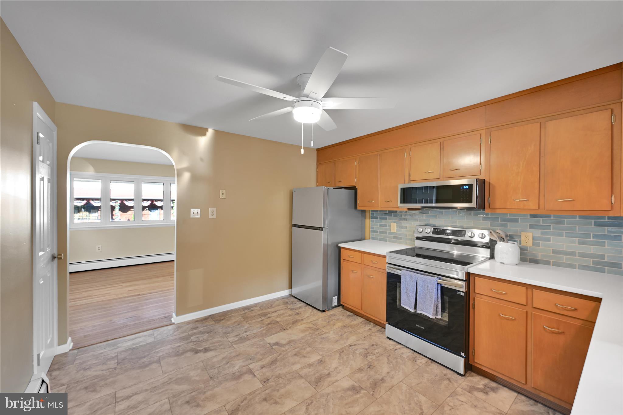 986 Fritztown Road Reading, PA 19608 - Photo 16 of 45 a kitchen with stainless steel appliances granite countertop a stove refrigerator and microwave