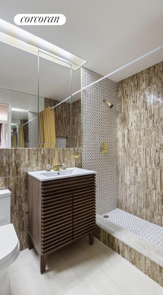 900 5th Avenue, Unit 10C Manhattan, NY 10021 - Photo 13 of 15 a bathroom with a sink and mirror