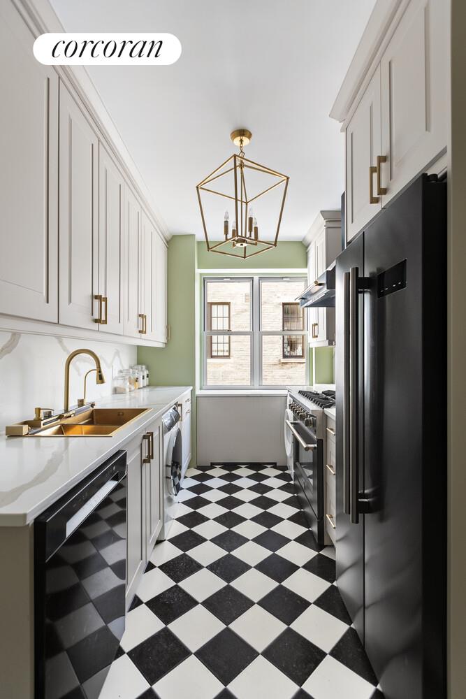 900 5th Avenue, Unit 10C Manhattan, NY 10021 - Photo 4 of 15 a kitchen with stainless steel appliances a refrigerator a sink a stove a microwave and dining table