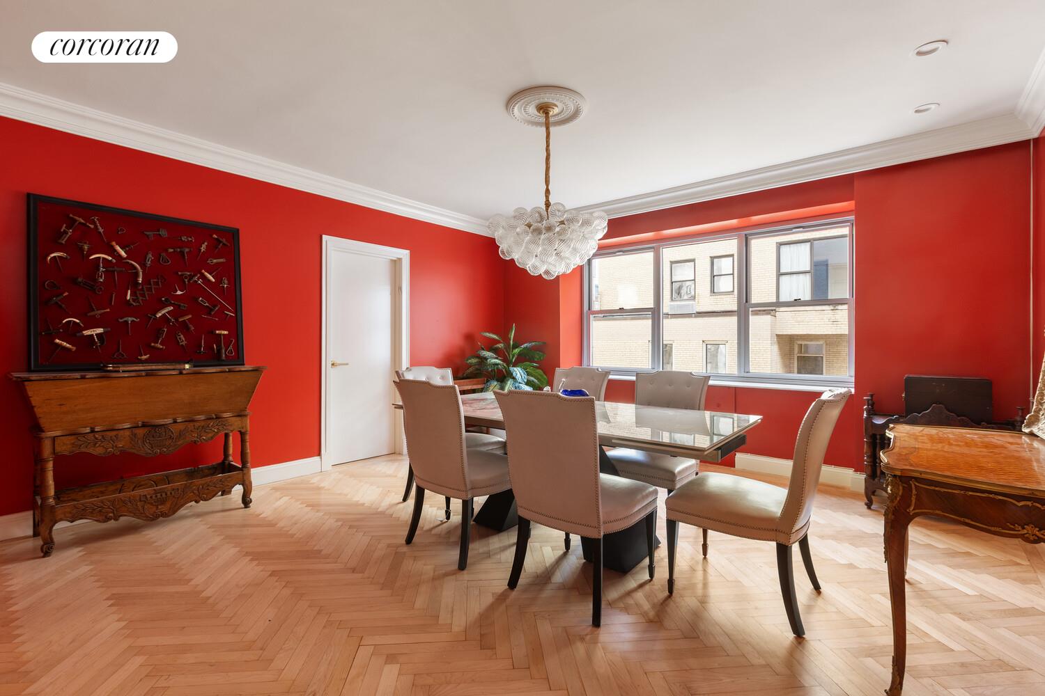 900 5th Avenue, Unit 10C Manhattan, NY 10021 - Photo 5 of 15 a dining room with furniture a window and a chandelier
