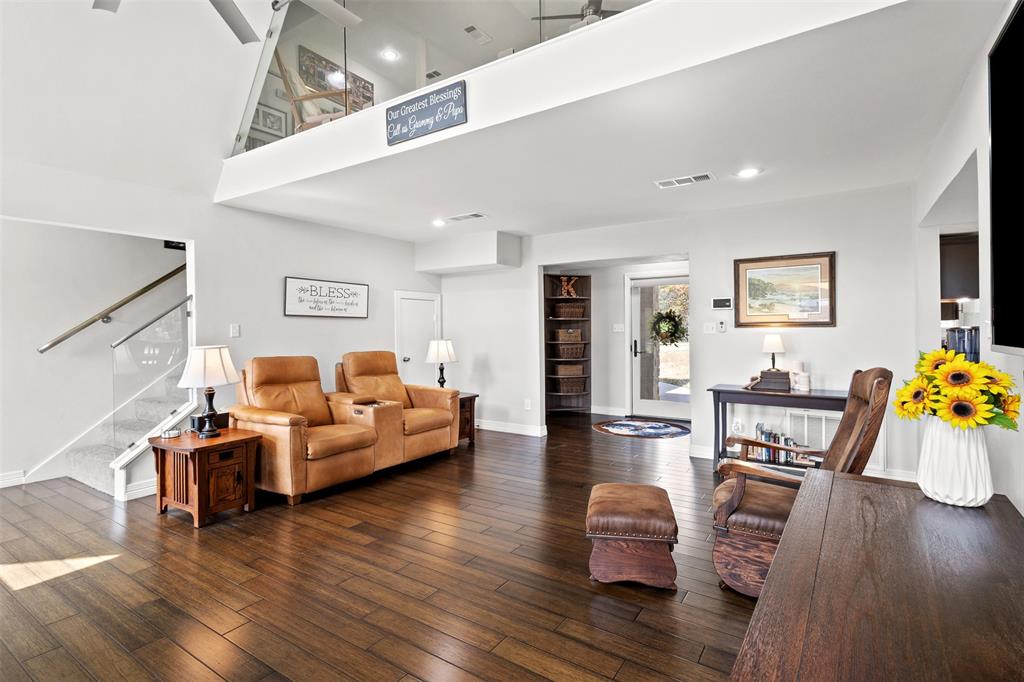 668 Cleve Cole Road Denison, TX 75021 - Photo 6 of 38 Vaulted ceiling, wood-finish flooring, glass panel stairway, recessed lighting, and an open loft area