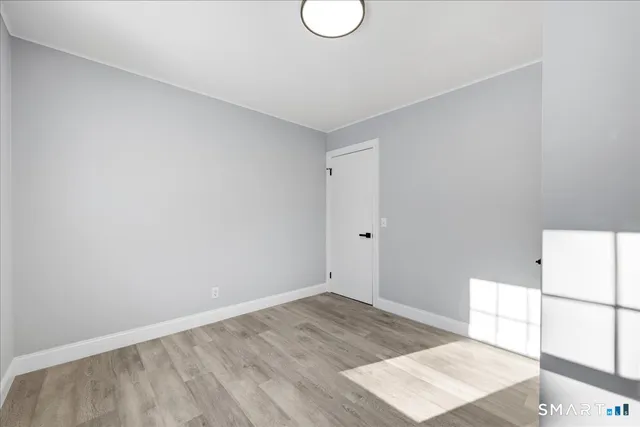 a view of a room with wooden floor and sink