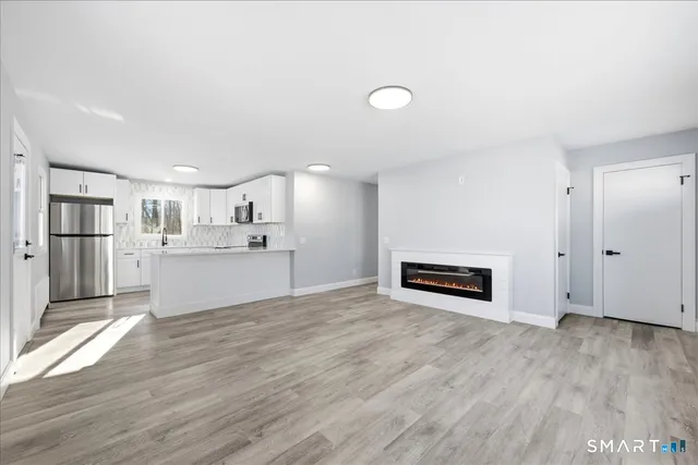 a view of a kitchen with wooden floor and windows