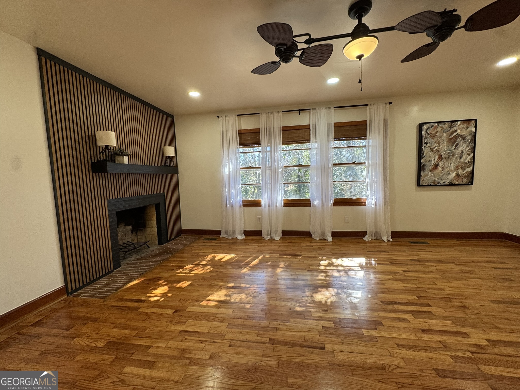 410 Sunset Circle Forsyth, GA 31029 - Photo 13 of 27 a view of an empty room with a fireplace and a window