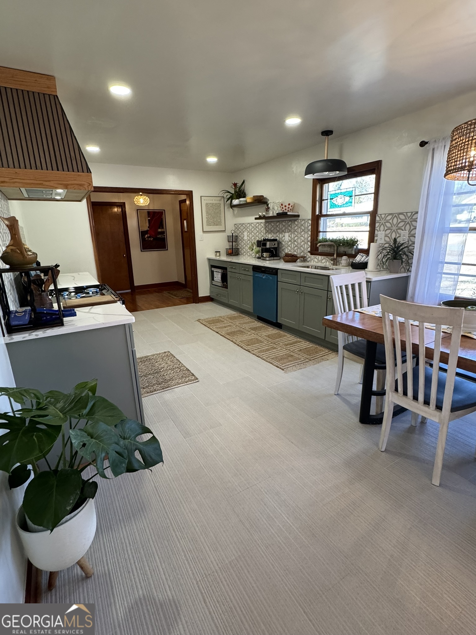 410 Sunset Circle Forsyth, GA 31029 - Photo 14 of 27 a kitchen with stainless steel appliances kitchen island granite countertop a sink and a stove