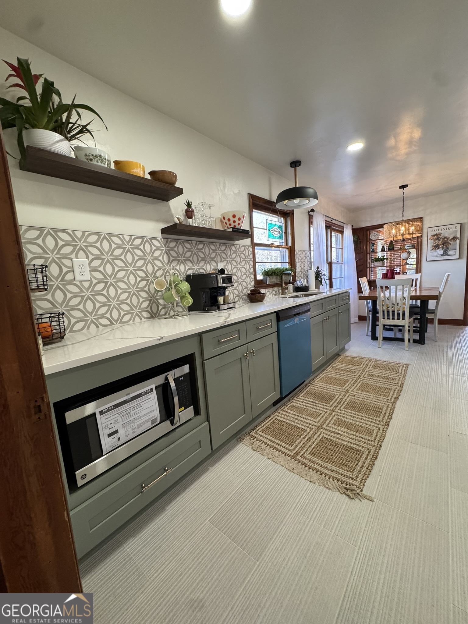 410 Sunset Circle Forsyth, GA 31029 - Photo 17 of 27 a kitchen with stainless steel appliances granite countertop a stove and cabinets