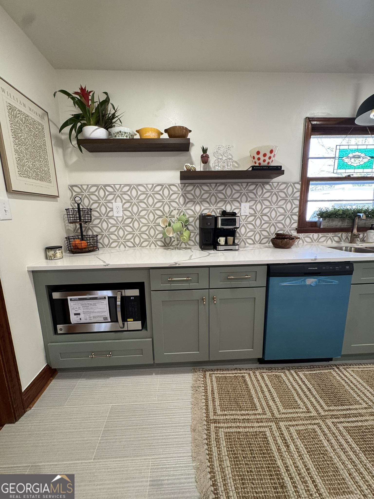 410 Sunset Circle Forsyth, GA 31029 - Photo 18 of 27 a kitchen with stainless steel appliances granite countertop a sink and cabinets