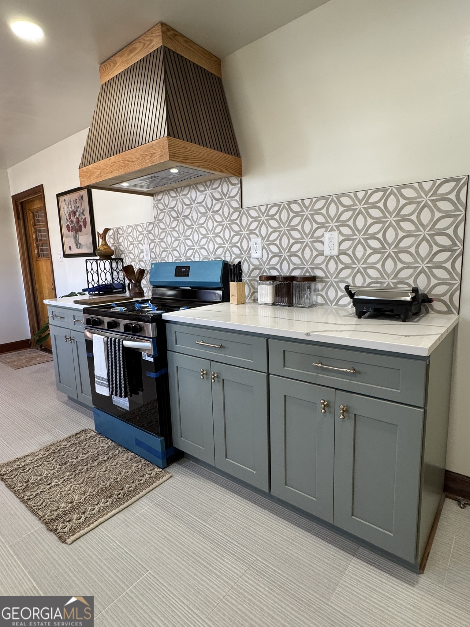 410 Sunset Circle Forsyth, GA 31029 - Photo 19 of 27 a kitchen with stainless steel appliances granite countertop a stove a sink and a microwave