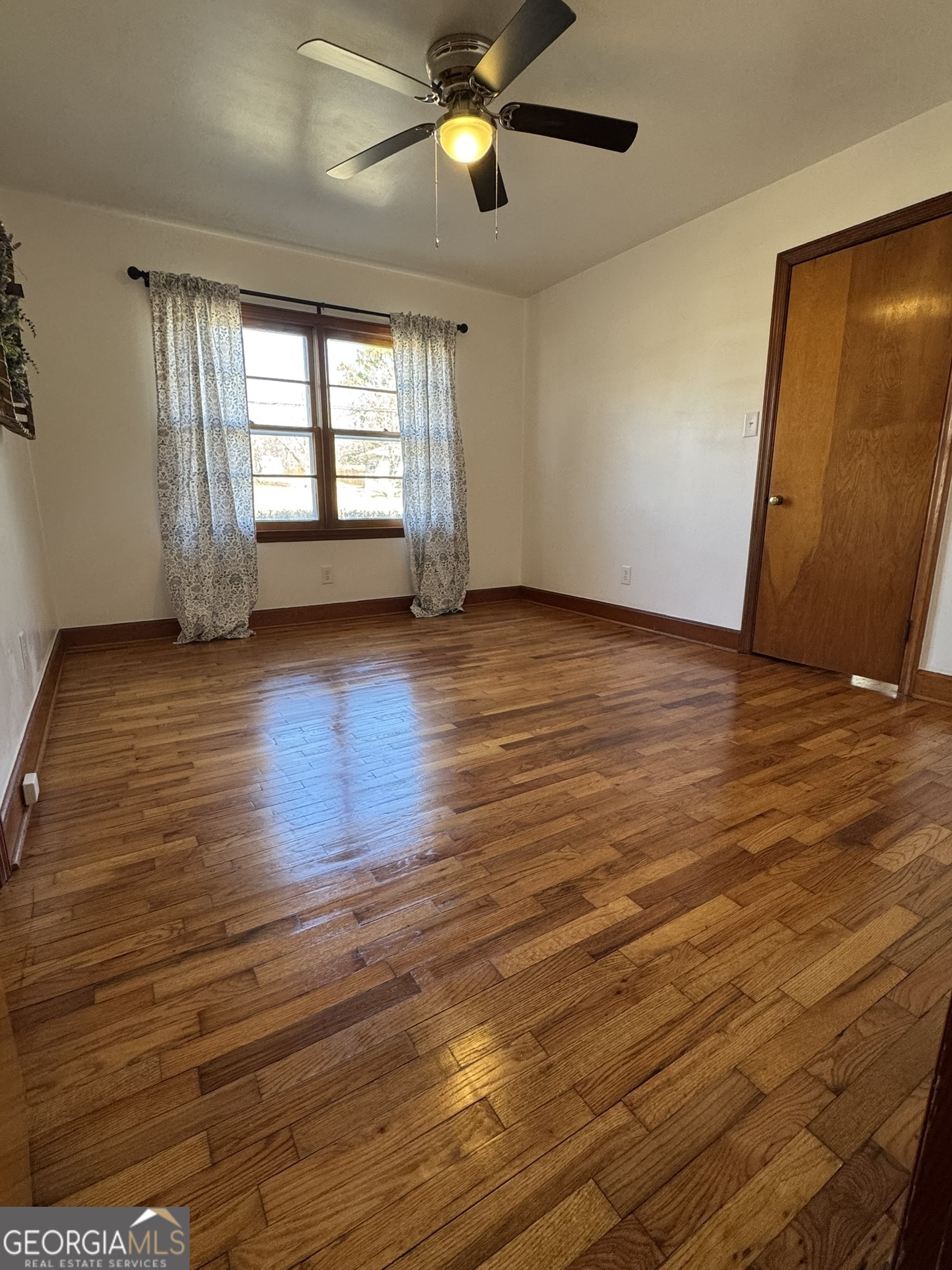410 Sunset Circle Forsyth, GA 31029 - Photo 2 of 27 a view of empty room with wooden floor and fan
