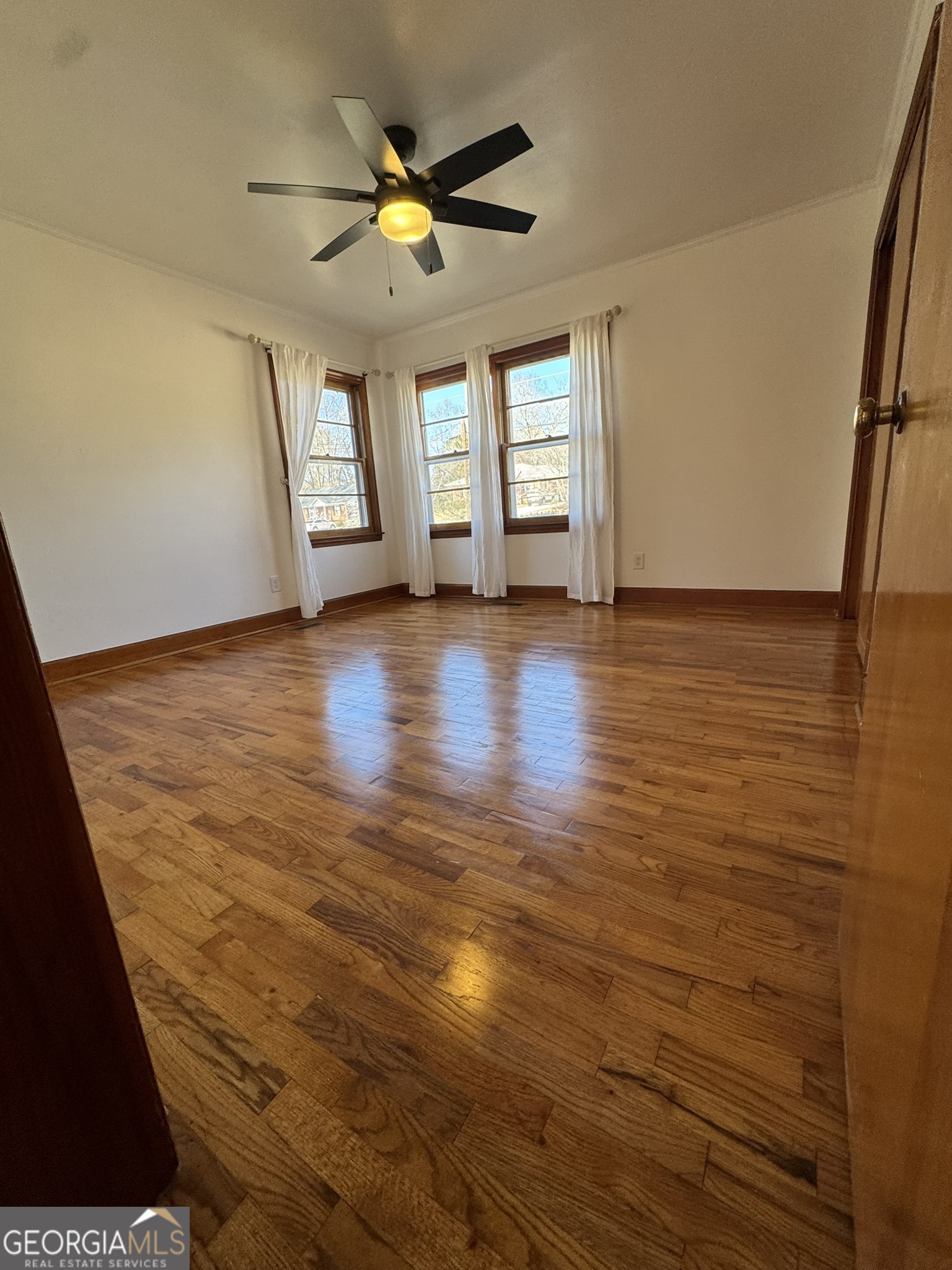 410 Sunset Circle Forsyth, GA 31029 - Photo 3 of 27 wooden floor in an empty room with a window