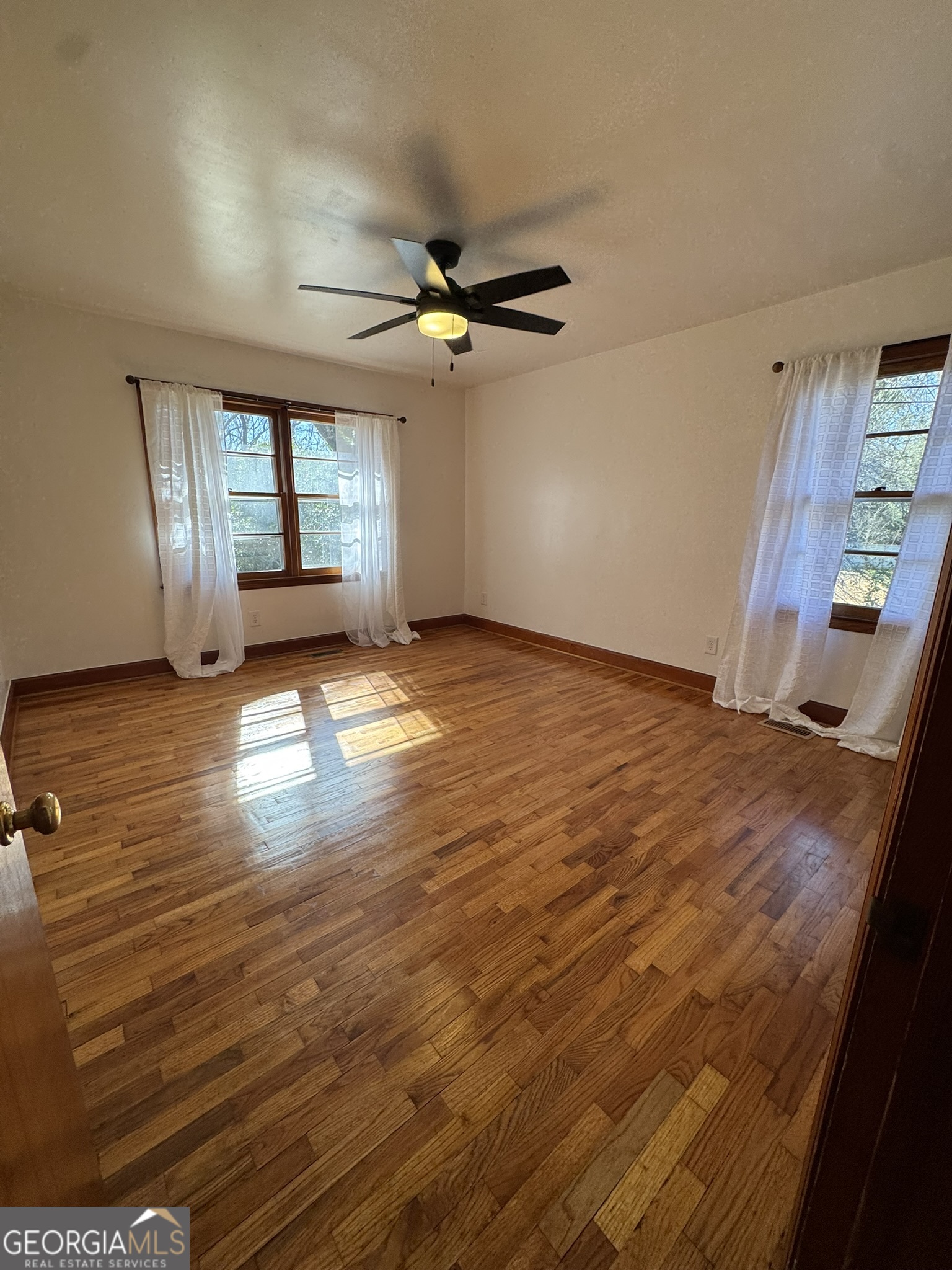 410 Sunset Circle Forsyth, GA 31029 - Photo 4 of 27 wooden floor in an empty room with a window