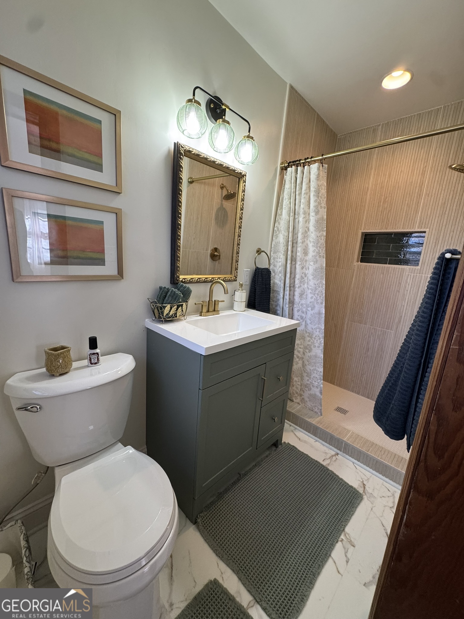 410 Sunset Circle Forsyth, GA 31029 - Photo 5 of 27 a bathroom with a sink a toilet a mirror and shower