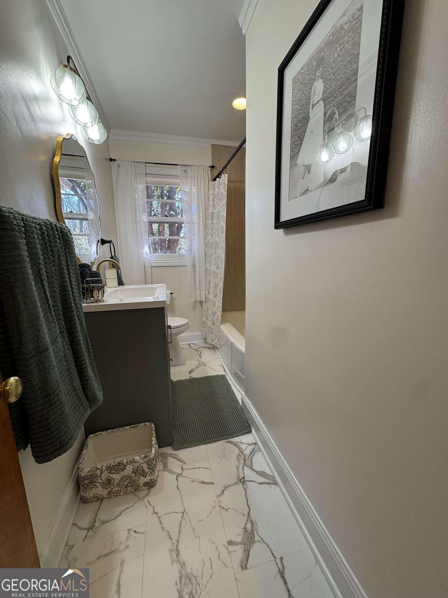 410 Sunset Circle Forsyth, GA 31029 - Photo 6 of 27 a bedroom with a bed and bathroom with mirror