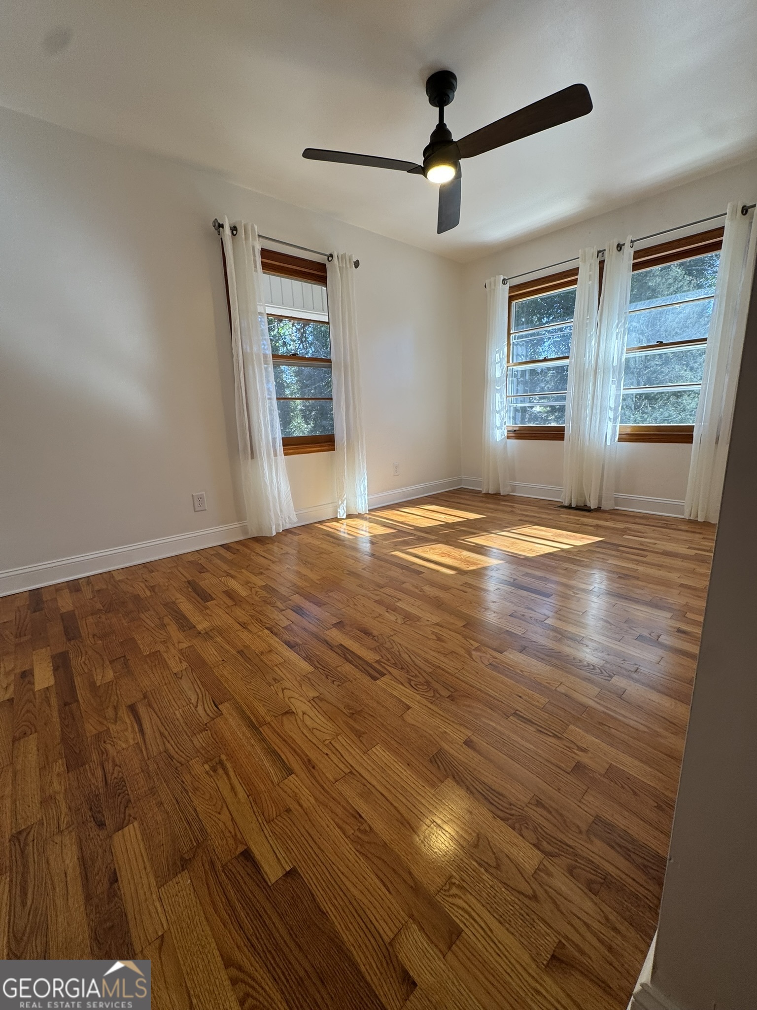 410 Sunset Circle Forsyth, GA 31029 - Photo 10 of 27 a view of an empty room with wooden floor and a window