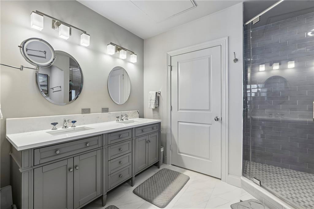 3445 Stratford Road Northeast, Unit 3105 Atlanta, GA 30326 - Photo 22 of 47 a spacious bathroom with a double vanity sink mirror and shower