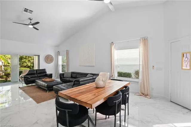 a dining room with furniture and wooden floor